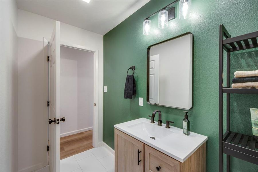 Bathroom featuring tile patterned flooring and vanity