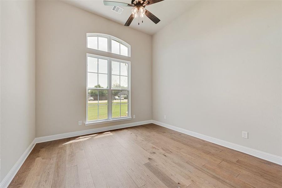 Empty room with light wood-style flooring and a ceiling fan