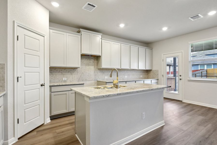 Kitchen in the Red River floorplan at a Meritage Homes community.