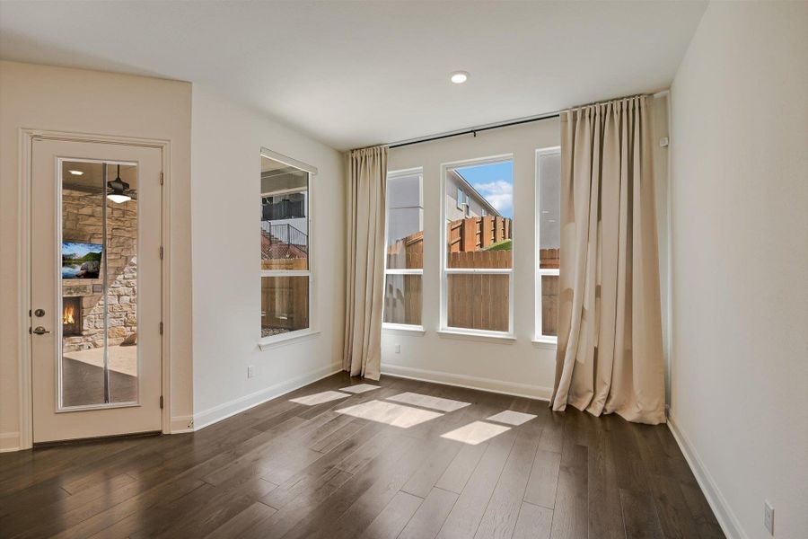 Doorway to outside with a stone fireplace, dark wood-type flooring, and recessed lighting Doorway to outside with a stone fireplace, dark wood-type flooring, and recessed lighting