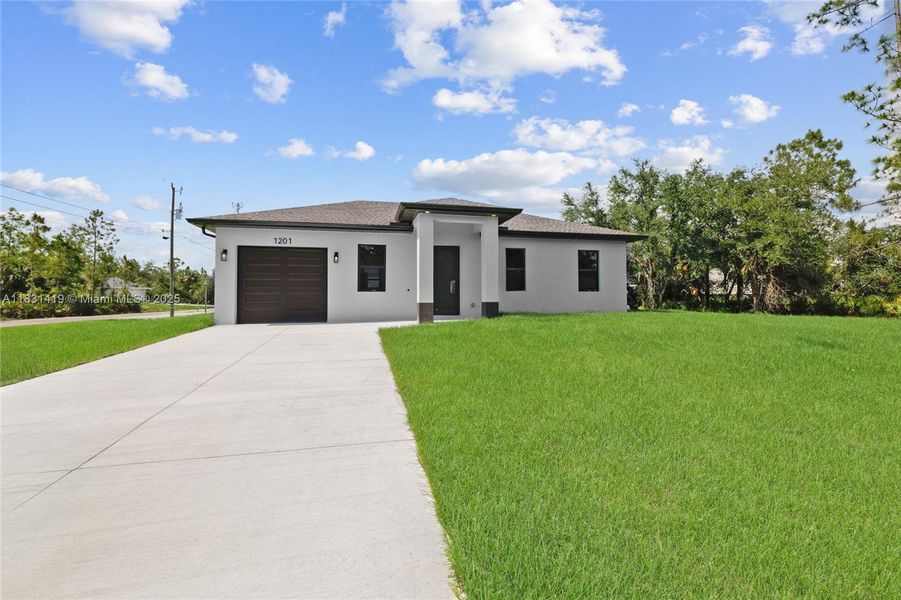 Front exterior of a new home in , Lehigh Acres, FL, highlighting curb appeal (Image 2).