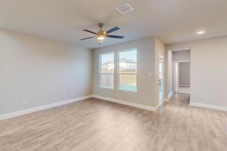 Unfurnished room with light hardwood / wood-style flooring and ceiling fan