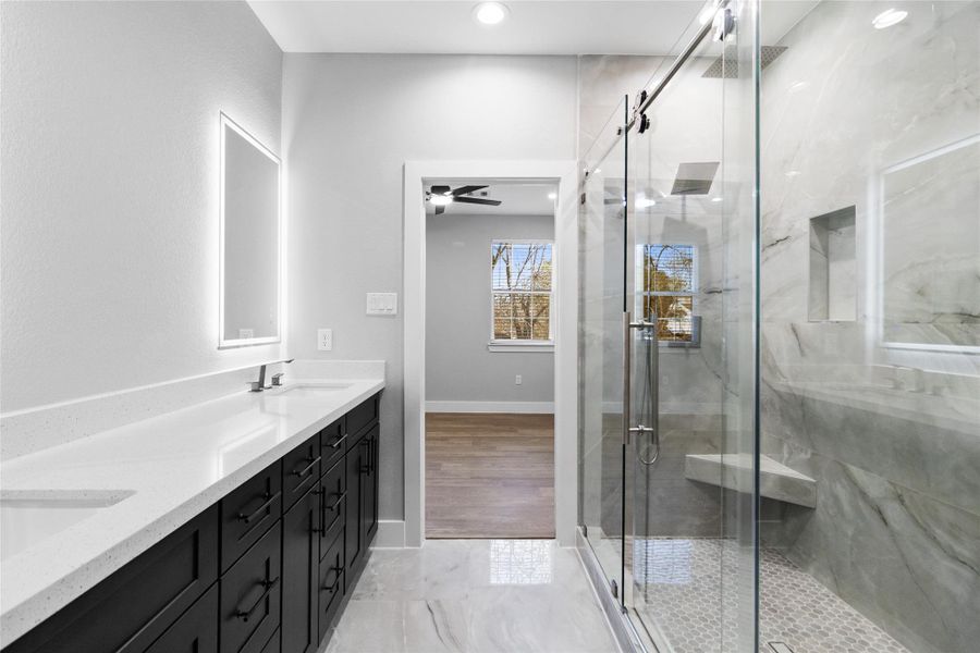 The walk-in shower, framed in glass and marble-style tile, gives you a daily dose of luxury while leading straight into your roomy closet. The walk-in shower, framed in glass and marble-style tile, gives you a daily dose of luxury while leading straight into your roomy closet.