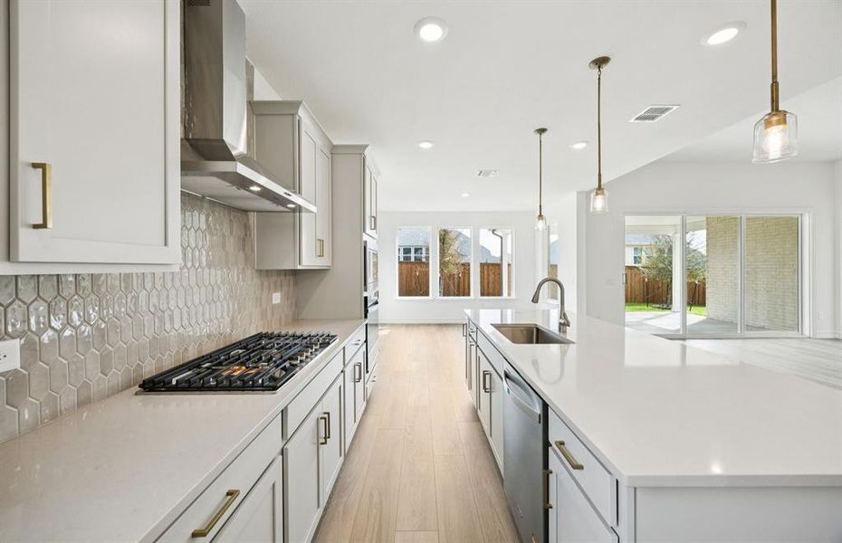 Open kitchen with adjoining nook featuring large windows and direct access to the backyard Open kitchen with adjoining nook featuring large windows and direct access to the backyard