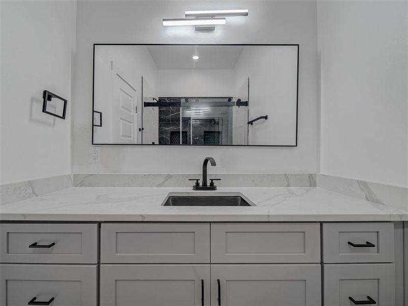 Bathroom featuring vanity and walk in shower