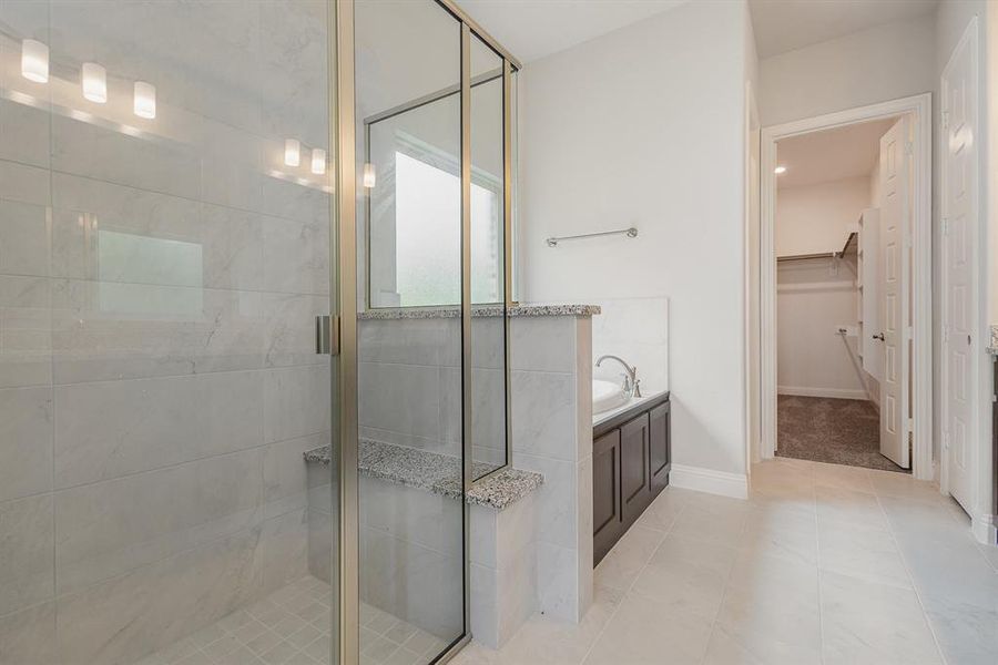 Bathroom featuring plus walk in shower and tile patterned floors