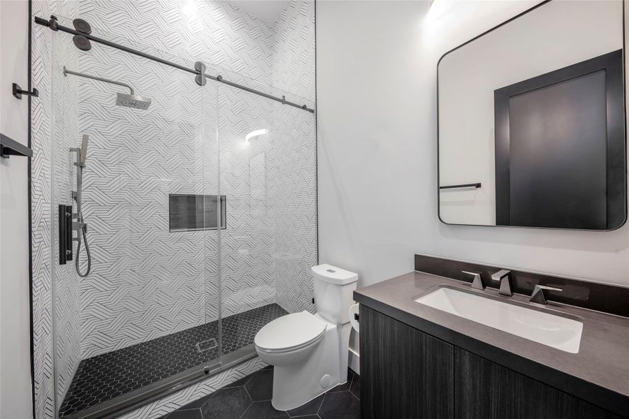 Example of Builders previously built home with similar finishes. Secondary bathroom showcasing a unique style, blending design creativity with functional elegance.