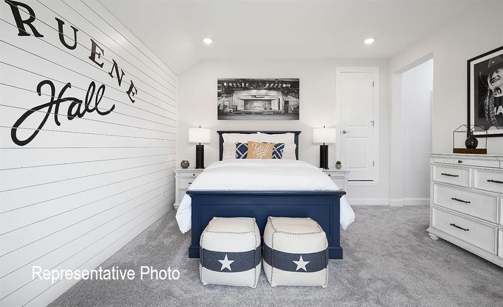 White shiplap accent wall, recessed lighting, white trim, grey carpeting, and a white six-drawer dresser with dark hardware