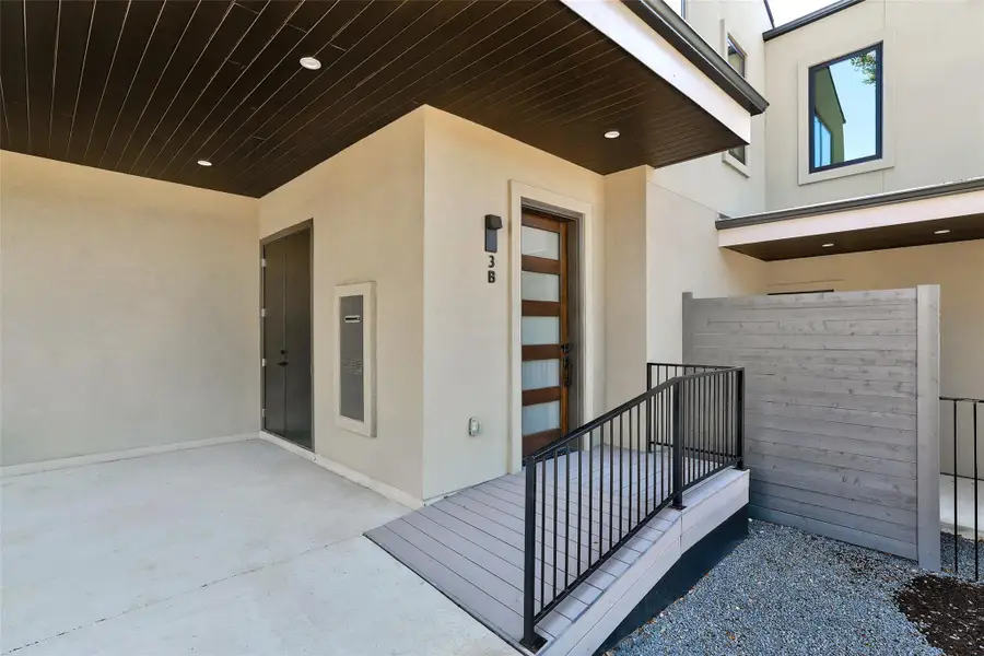 View of exterior entry featuring stucco siding and a patio