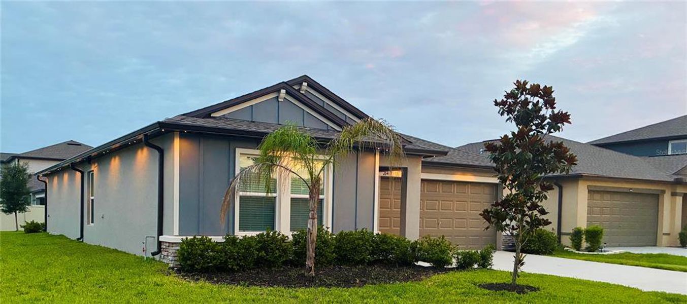 Front exterior of a new home in Two Rivers, Zephyrhills, FL, highlighting curb appeal (Image 18).