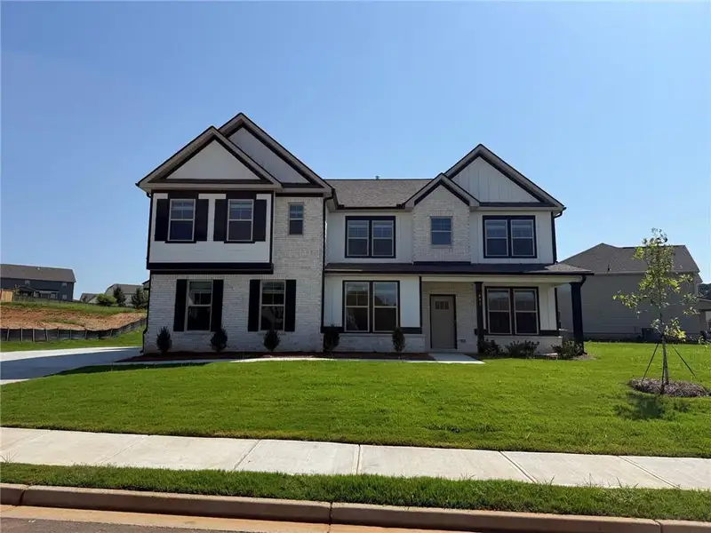 Front exterior of a new home in Grandview at Millers Mill, Stockbridge, GA, highlighting curb appeal (Image 1). Front exterior of a new home in Grandview at Millers Mill, Stockbridge, GA, highlighting curb appeal (Image 1).