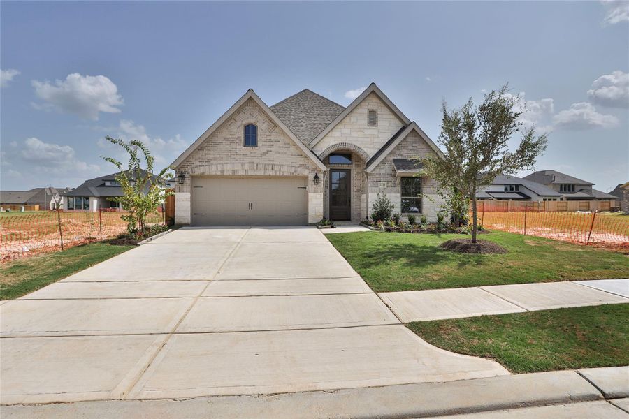 Front exterior of a new home in Everly, Hockley, TX, highlighting curb appeal (Image 2).