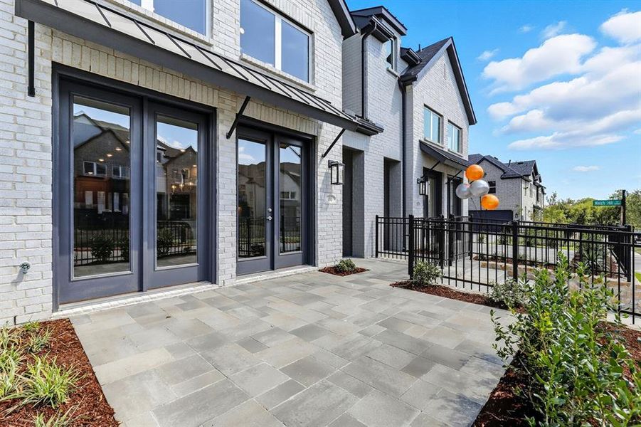 Front exterior of a new home in Walsh: Townhomes - The Patios, Aledo, TX, highlighting curb appeal (Image 1). Front exterior of a new home in Walsh: Townhomes - The Patios, Aledo, TX, highlighting curb appeal (Image 1).
