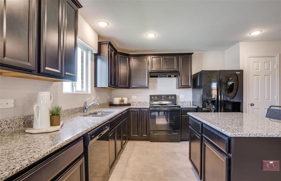 Bright kitchen with ample cabinet space 
 *Photos of furnished model. Not actual home. Representative of floor plan. Some options and features may vary