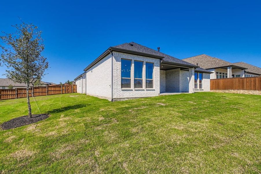 Front exterior of a new home in Reunion 70s, Rhome, TX, highlighting curb appeal (Image 1). Front exterior of a new home in Reunion 70s, Rhome, TX, highlighting curb appeal (Image 1).