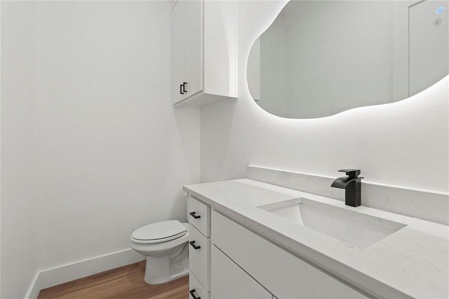 Contemporary vanity with an integrated sink, solid surface countertop, and matte black waterfall faucet