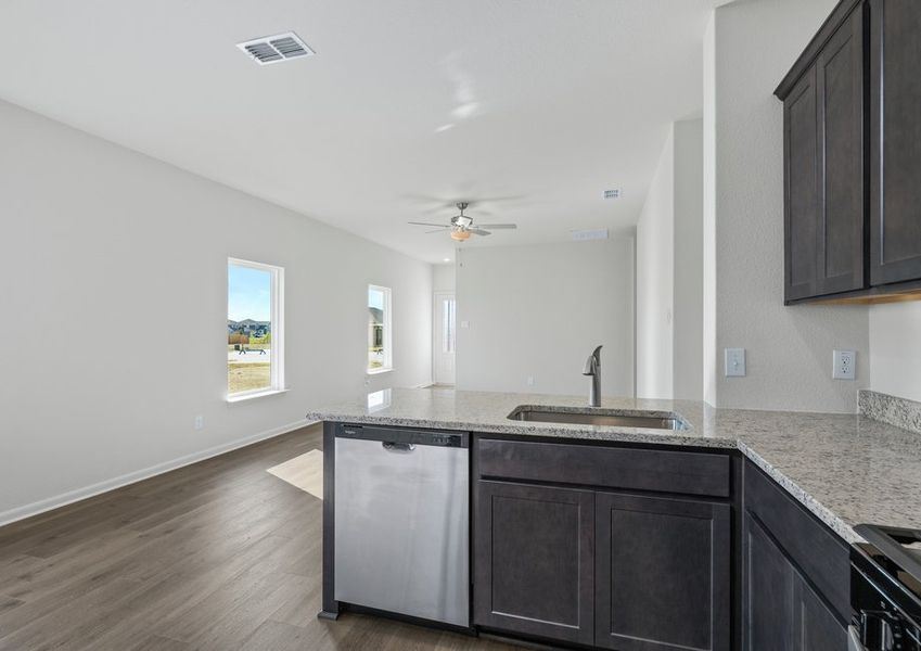 The kitchen looks out at the family room.