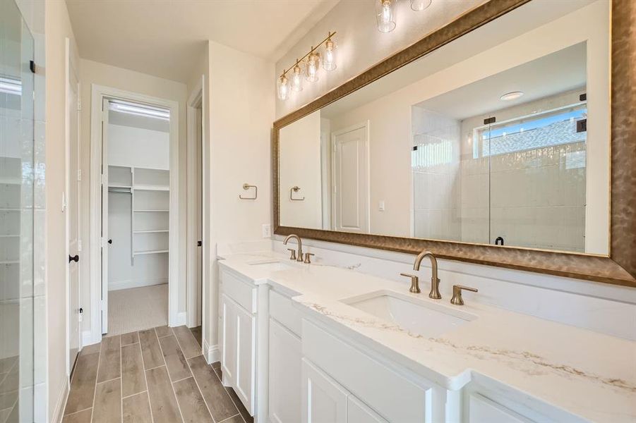 Bathroom with vanity and a shower with door