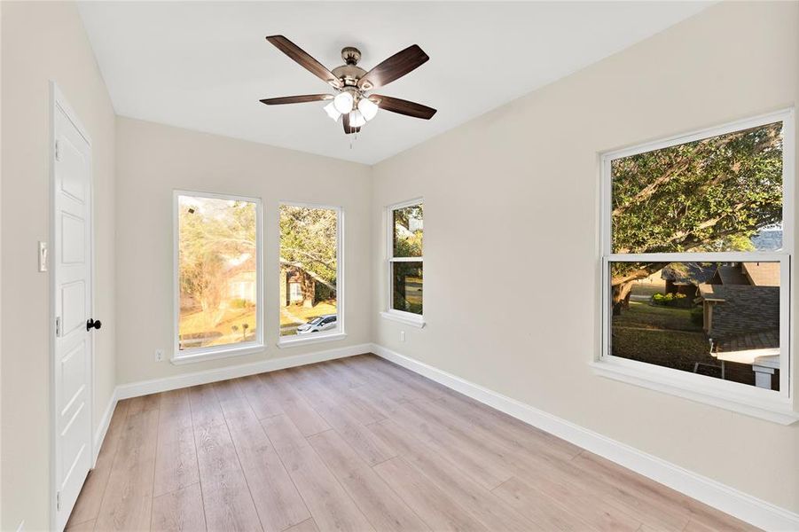 Spare room featuring ceiling fan and light wood-type flooring