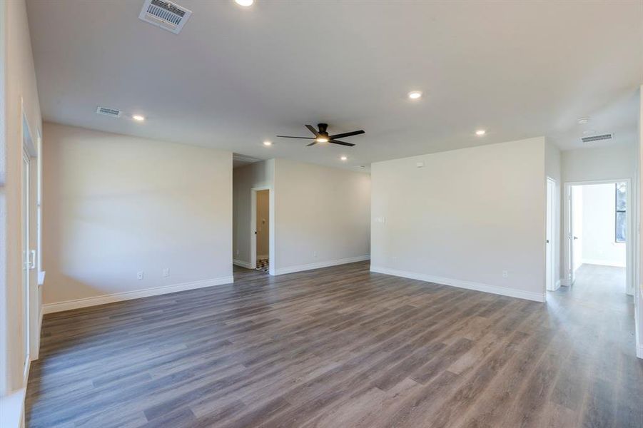 Living room featuring ceiling fan and dark hardwood / wood-style floors