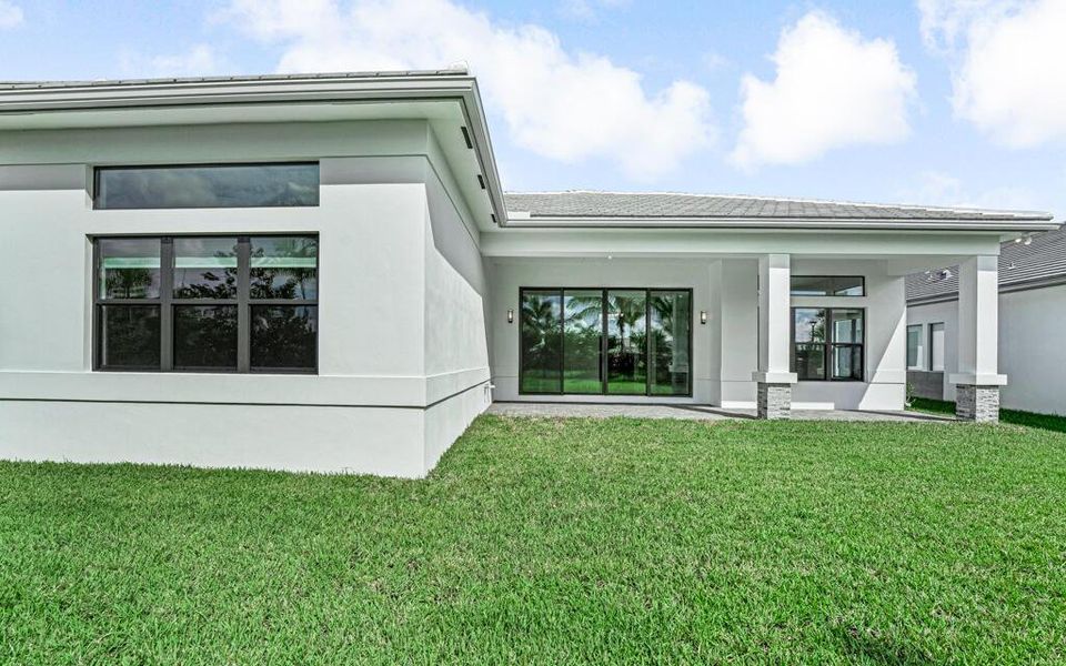 Front exterior of a new home in Apex at Avenir, Palm Beach Gardens, FL, highlighting curb appeal (Image 1). Front exterior of a new home in Apex at Avenir, Palm Beach Gardens, FL, highlighting curb appeal (Image 1).
