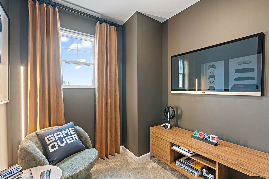 A living room with a tv and a couch. A living room with a tv and a couch.