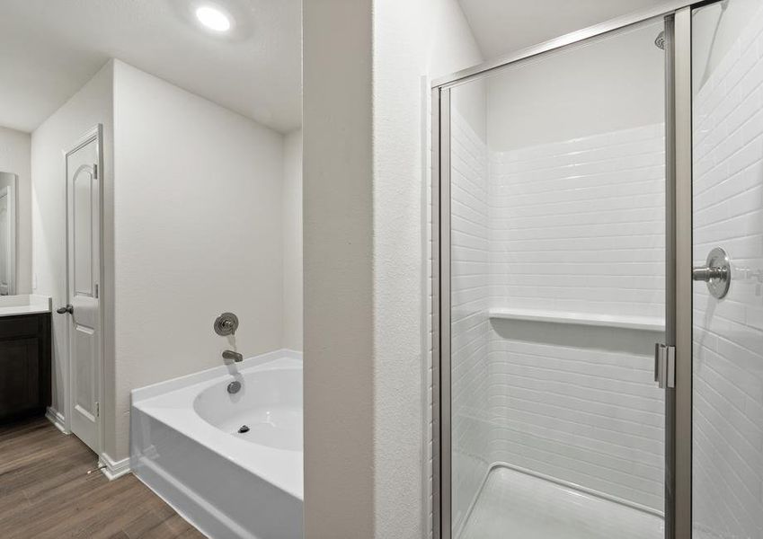 The master bathroom of the Rayburn has a glass, walk-in shower and garden tub.