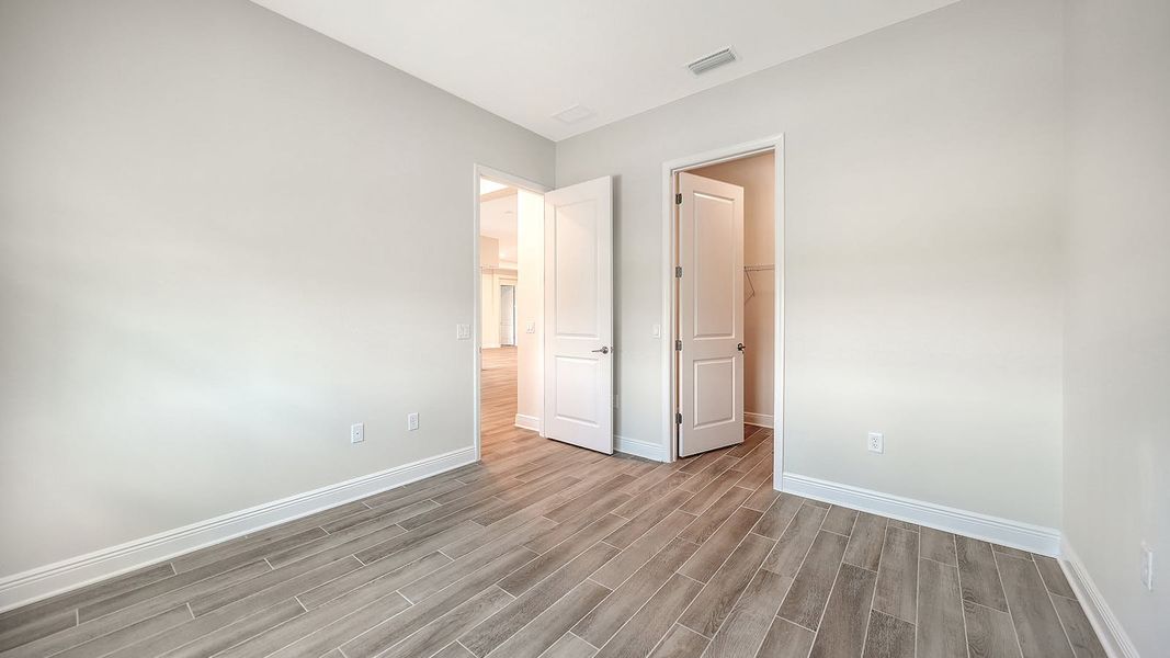 Spacious, unfurnished interior of a new home in Canoe Creek Real Estate and Homes for Sale in Parrish, FL - Neal Communities, Parrish (Image 61).