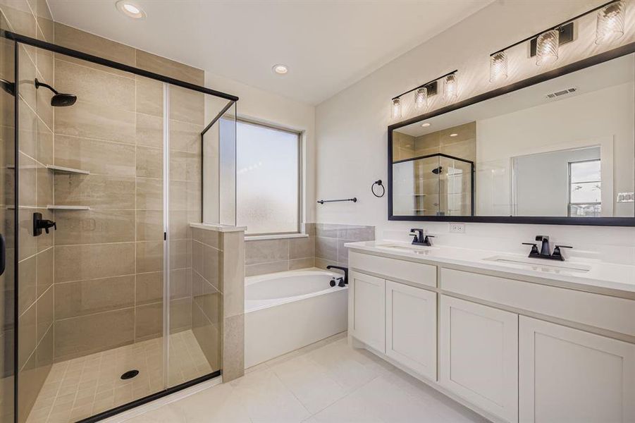 Bathroom with double vanity, a bath, a shower stall, light tile patterned flooring, and recessed lighting Bathroom with double vanity, a bath, a shower stall, light tile patterned flooring, and recessed lighting