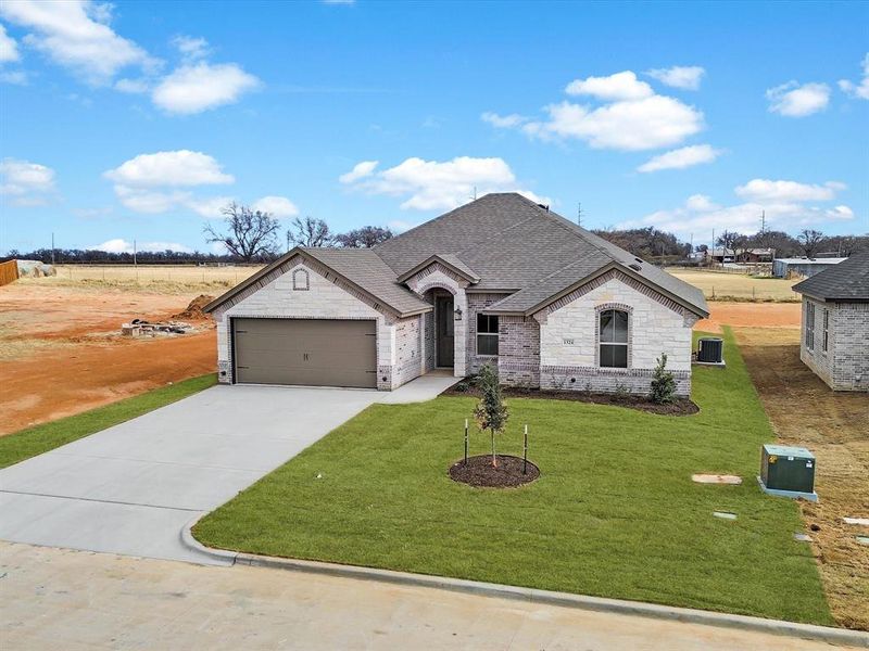 Front exterior of a new home in , Tolar, TX, highlighting curb appeal (Image 2). Front exterior of a new home in , Tolar, TX, highlighting curb appeal (Image 2).