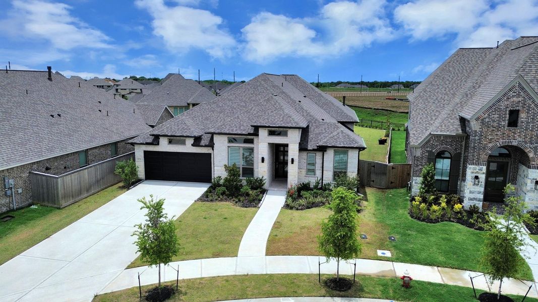 Front exterior of a new home in Valencia, Manvel, TX, highlighting curb appeal (Image 26). Front exterior of a new home in Valencia, Manvel, TX, highlighting curb appeal (Image 26).