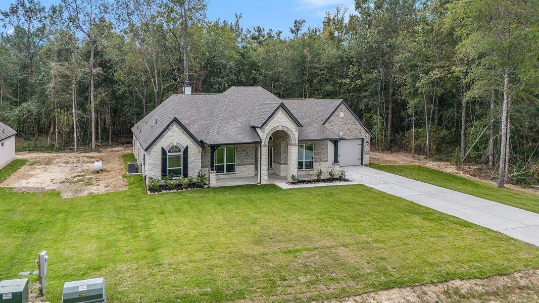 Front exterior of a new home in Encino Estates, Dayton, TX, highlighting curb appeal (Image 19).