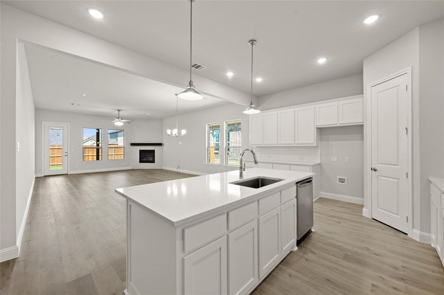 Kitchen featuring white cabinets, recessed lighting, a chandelier, decorative light fixtures, and open floor plan