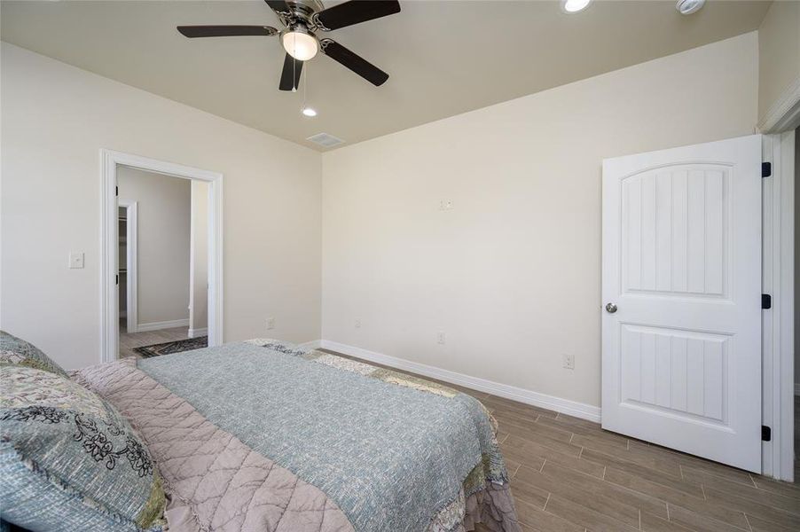 Bedroom with wood-type flooring and ceiling fan