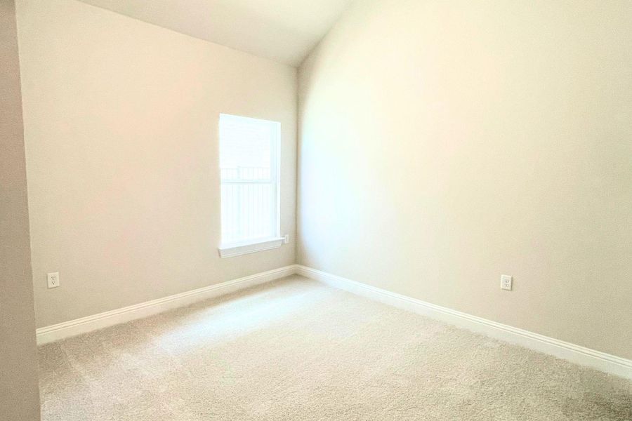 Plush carpeted floors and a vaulted ceiling elevate this sunlit, versatile space. Plush carpeted floors and a vaulted ceiling elevate this sunlit, versatile space.