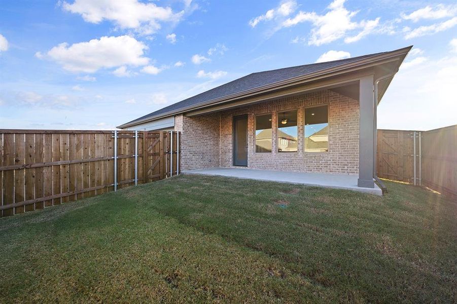 Rear view of property featuring brick siding, a patio, a fenced backyard, and a shingled roof Rear view of property featuring brick siding, a patio, a fenced backyard, and a shingled roof