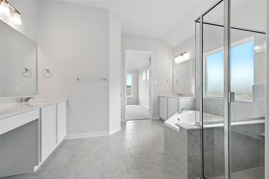 Bathroom with vanity, a garden tub, and lofted ceiling Bathroom with vanity, a garden tub, and lofted ceiling
