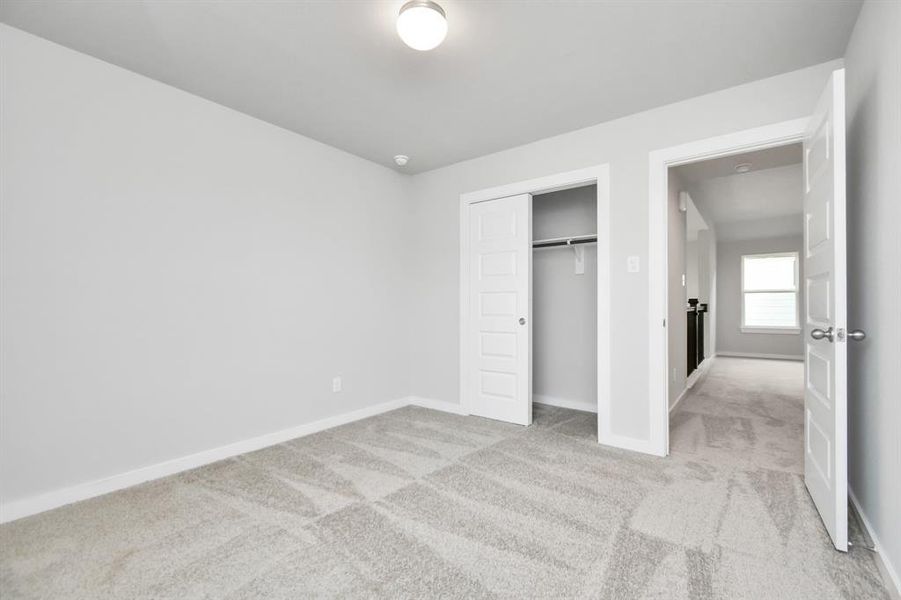 Generously sized secondary bedrooms featuring spacious closets, soft and inviting carpeting underfoot, large windows allowing plenty of natural light, and the added touch of privacy blinds for your personal retreat.