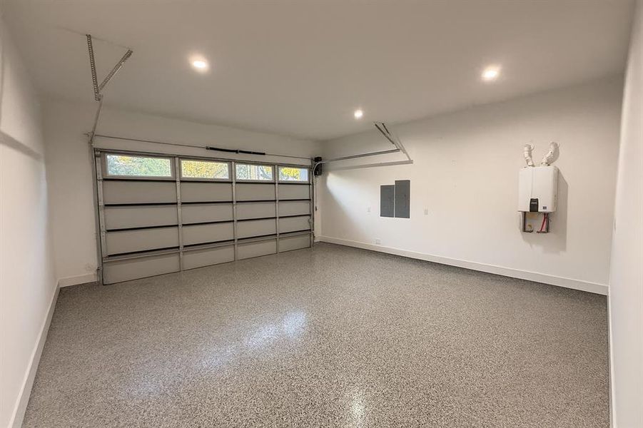 Garage with recessed lighting and electric panel