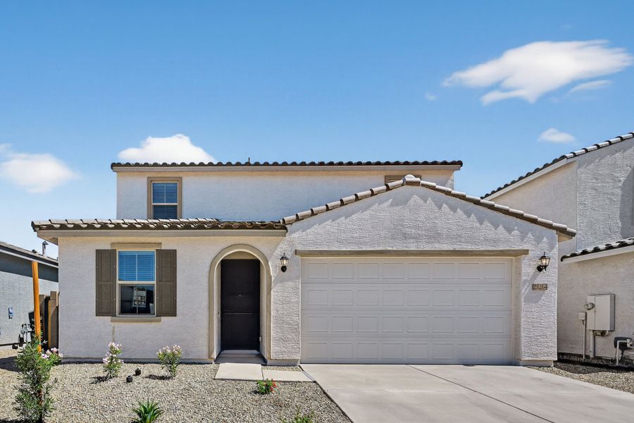 Front exterior of a new home in Artisan at Asante, Surprise, AZ, highlighting curb appeal (Image 1). Front exterior of a new home in Artisan at Asante, Surprise, AZ, highlighting curb appeal (Image 1).