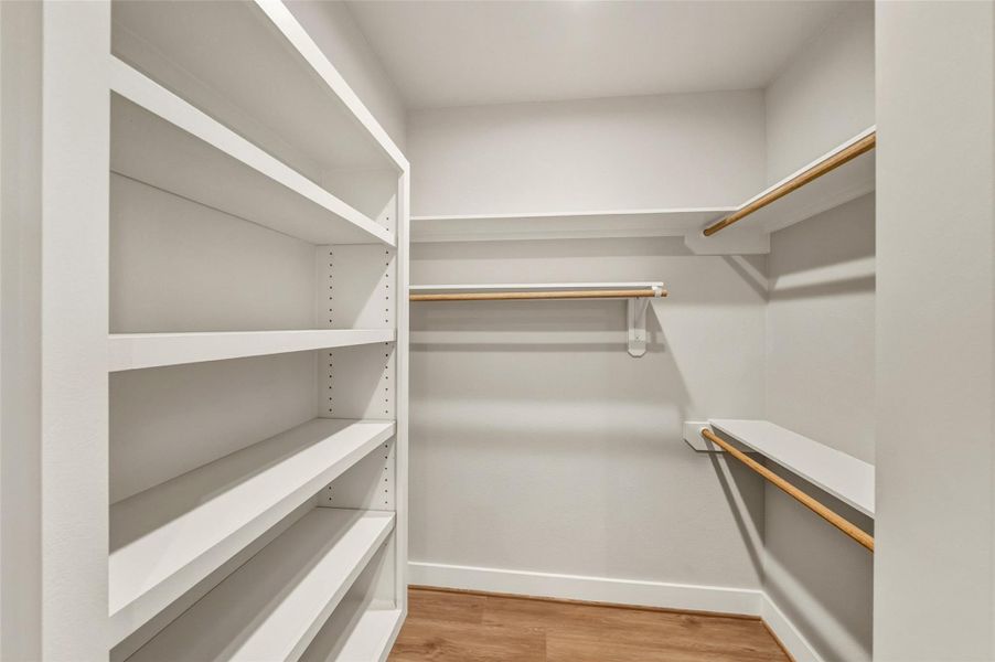 Discover the luxury of an expansive master walk-in closet, featuring ample shelving and hanging space to elegantly organize your wardrobe. Discover the luxury of an expansive master walk-in closet, featuring ample shelving and hanging space to elegantly organize your wardrobe.
