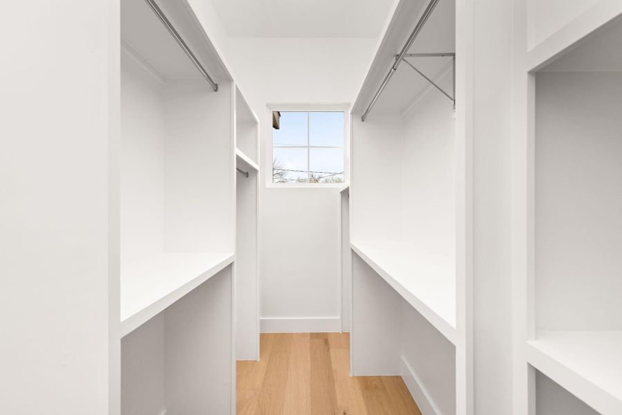 Walk in closet featuring light wood-style floors Walk in closet featuring light wood-style floors