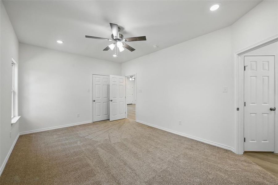 Unfurnished bedroom with recessed lighting, baseboards, light carpet, and ceiling fan Unfurnished bedroom with recessed lighting, baseboards, light carpet, and ceiling fan