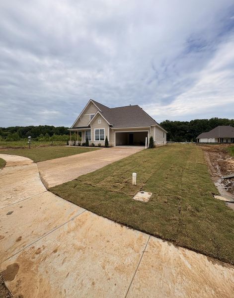 Single-story residence featuring a covered front porch, attached garage, concrete driveway, and newly laid sod Single-story residence featuring a covered front porch, attached garage, concrete driveway, and newly laid sod
