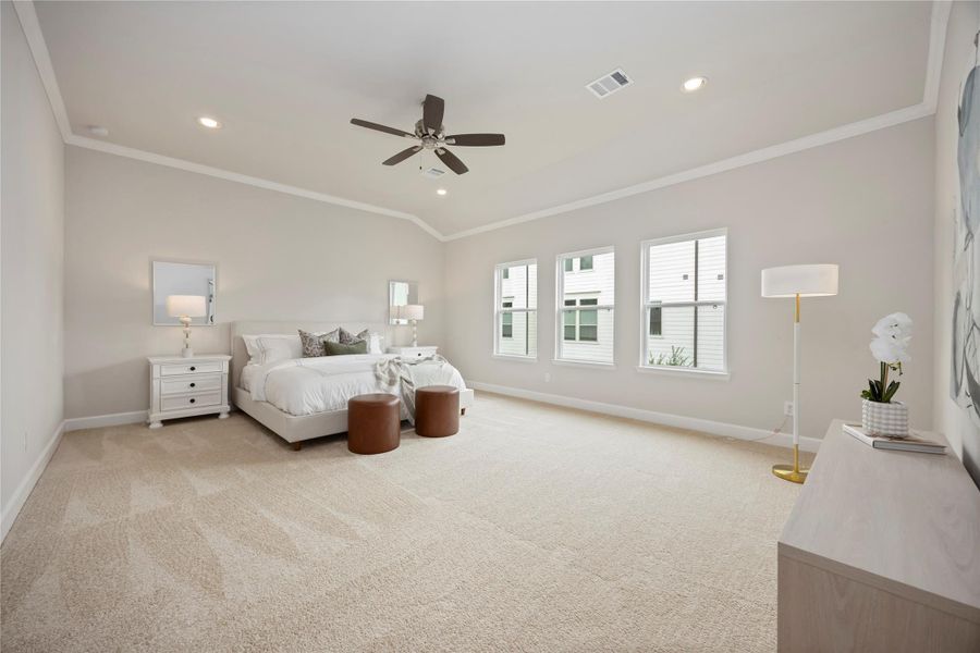 A sanctuary of light and luxury; this large, primary bedroom serves as a haven of tranquility and refined comfort.