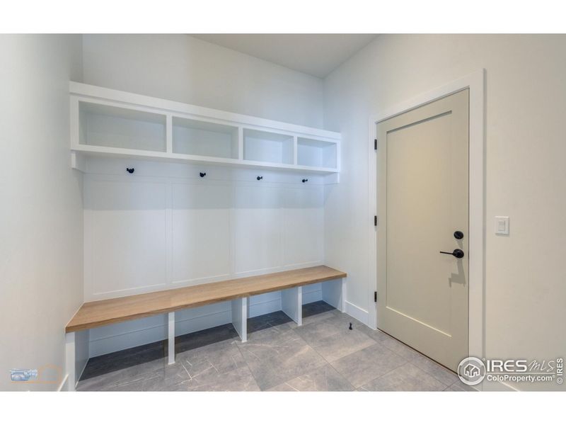 Mud Room With Bench & Cubbies. Tile Floor. Attached 2 Car Garage Is Finished. 18 Ft Wide Garage Door With Windows And Opener. Epoxy Floor Finish In Garage