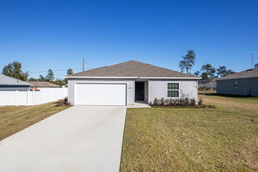Front exterior of a new home in Royal Highlands, Weeki Wachee, FL, highlighting curb appeal (Image 18).