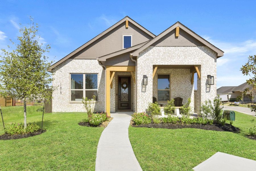 Front exterior of a new home in Riceland: 42ft. lots, Mont Belvieu, TX, highlighting curb appeal (Image 1).