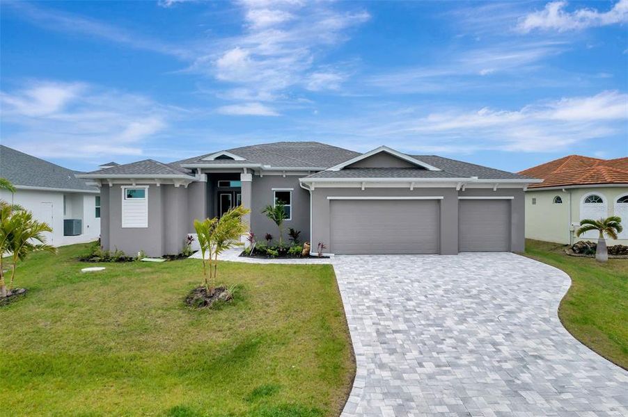 Front exterior of a new home in , Port Charlotte, FL, highlighting curb appeal (Image 1). Front exterior of a new home in , Port Charlotte, FL, highlighting curb appeal (Image 1).