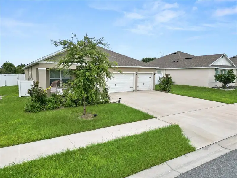 Front exterior of a new home in Wind Meadows South, Bartow, FL, highlighting curb appeal (Image 1). Front exterior of a new home in Wind Meadows South, Bartow, FL, highlighting curb appeal (Image 1).